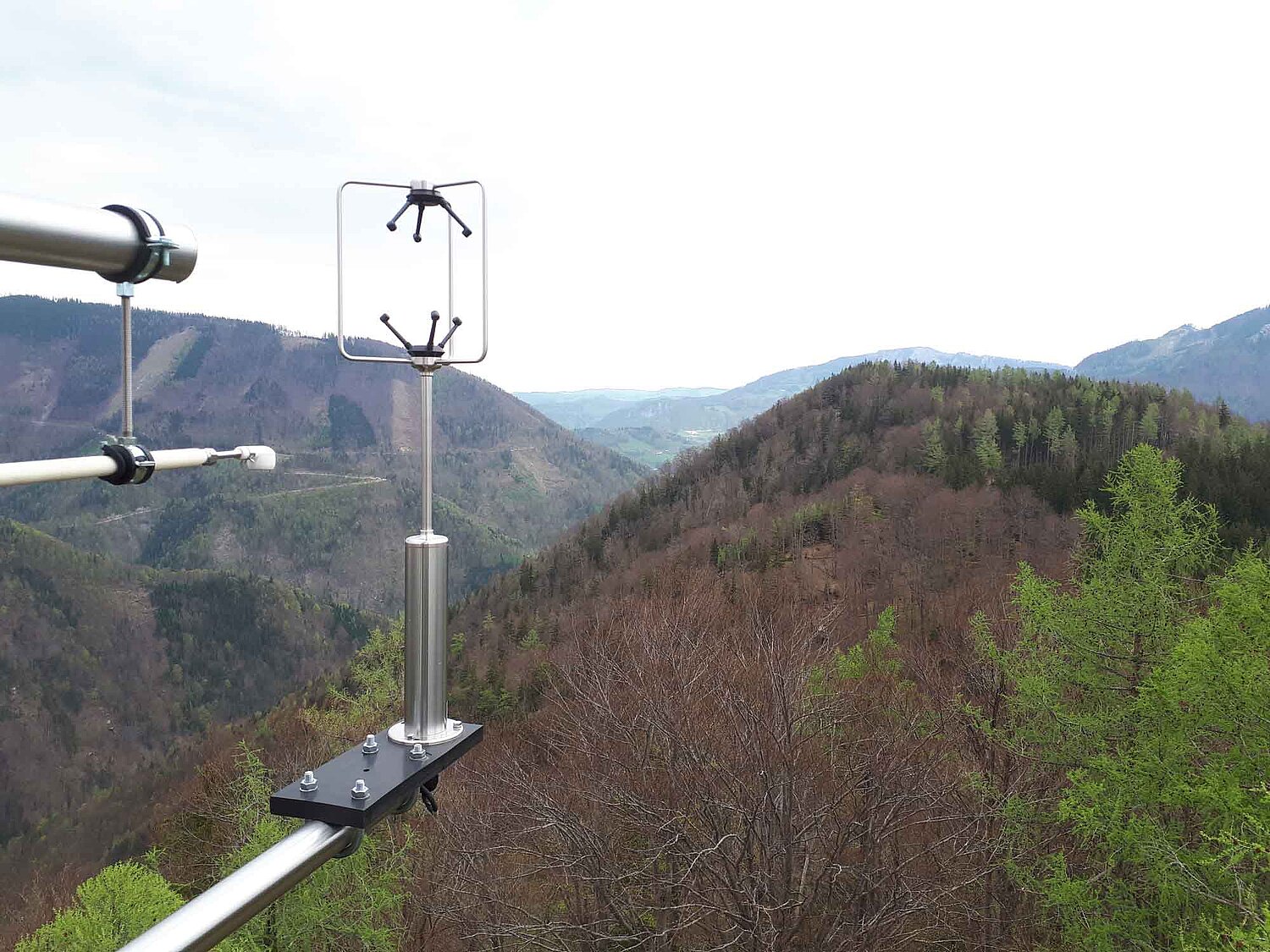 The picture shows the eddy-flux device measuring greenhouse gases in a mountain forest environment.  